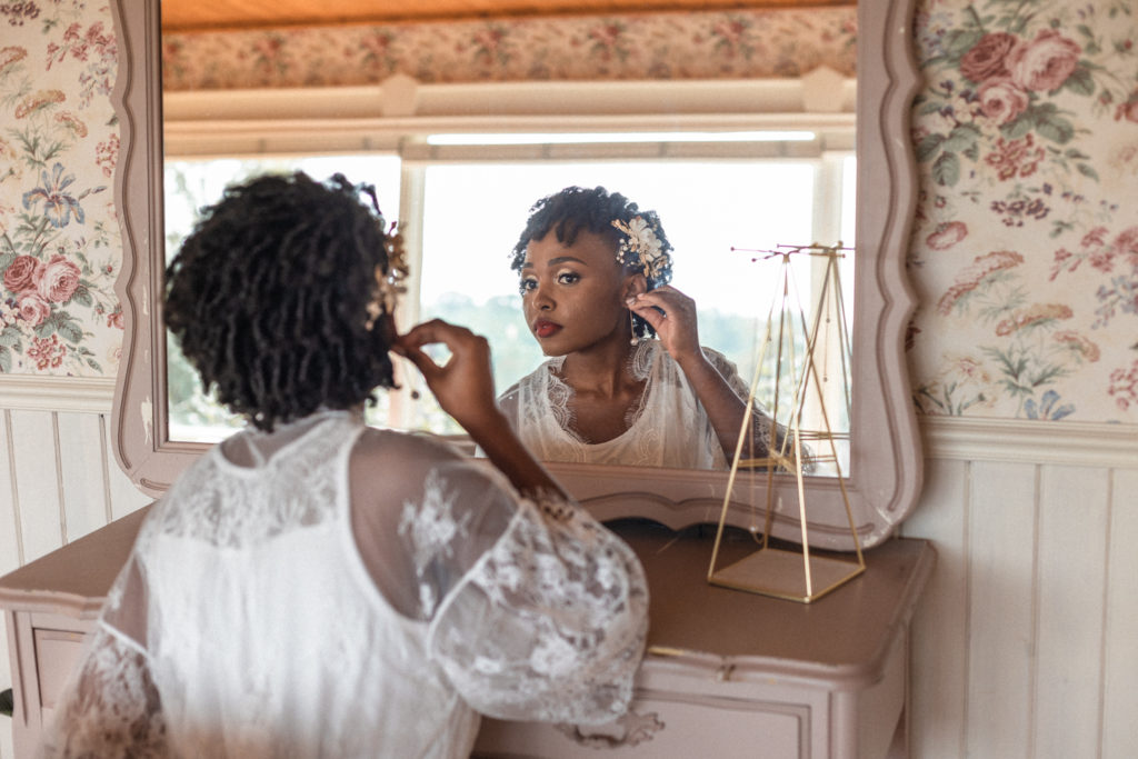 The bride uses the vintage makeup counter in the Maidenwood Weddings and Events wedding suite