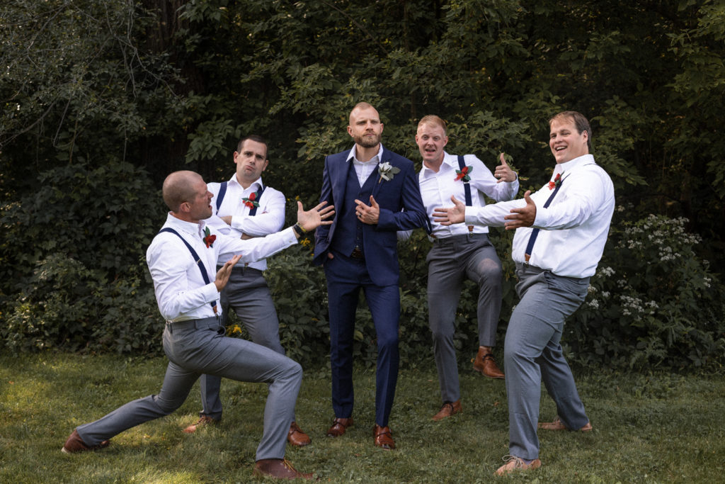 Groom and groomsmen making the best of the photo opportunity before the groom says "I do"