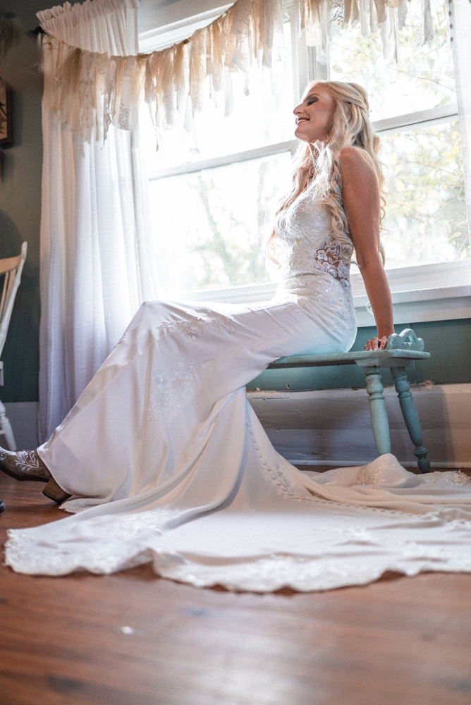 Beautiful bride enjoys a moment to herself before the start of her wedding celebrations at the barn at high point.