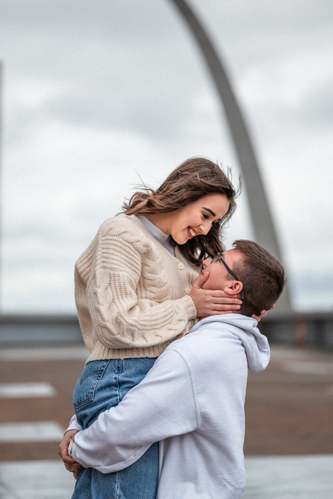 Couple spins each other around while trying to stay warm on a chilly day in st louis, mo.