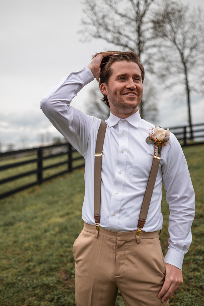 Groom in boho attires waits for his bride in excitement at lewallen farms
