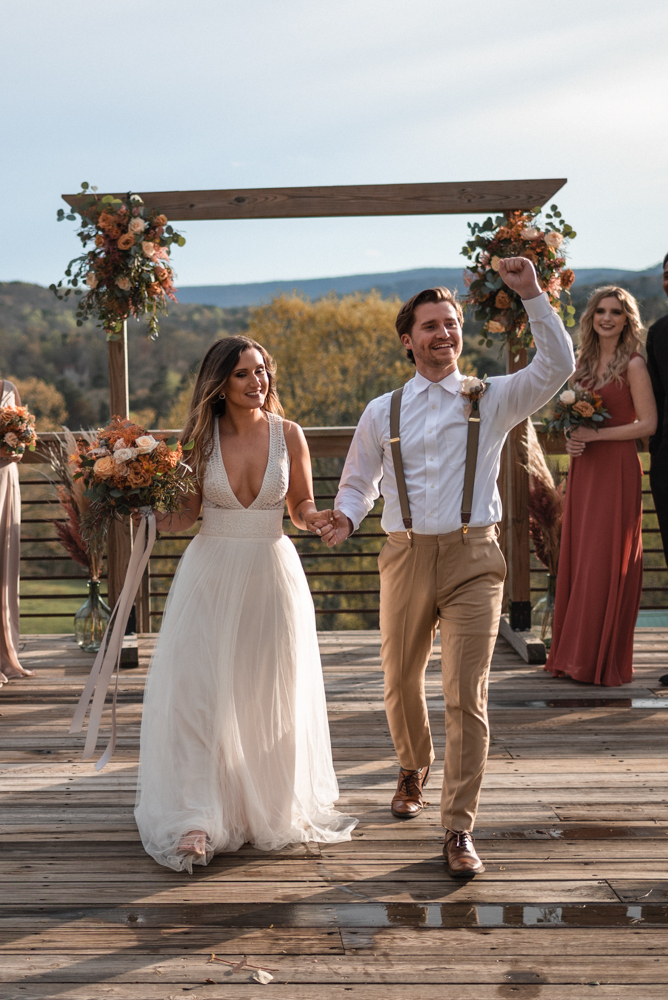 Groom does in fist pump in excitement as couple begins their future together