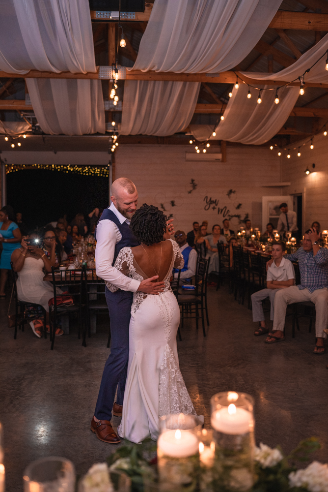Bride and groom enjoy their first dance with their family and friends at maidenwood weddings and events