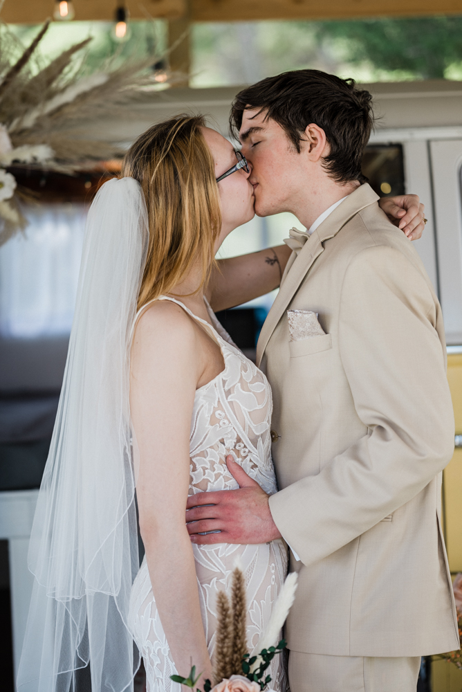 A first kiss celebrated by the new couple during their intimate elopement in st claire, mo