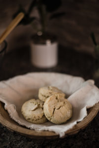 Fresh cooked gluten free vegan biscuits in bamboo bowl with bread towel from lake st louis vegan bakery.